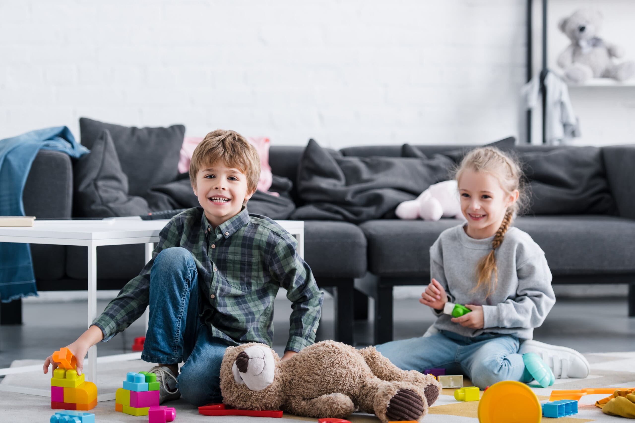 adorable-happy-children-sitting-on-floor-and-playi-2023-11-27-05-29-19-utc-scaled-min