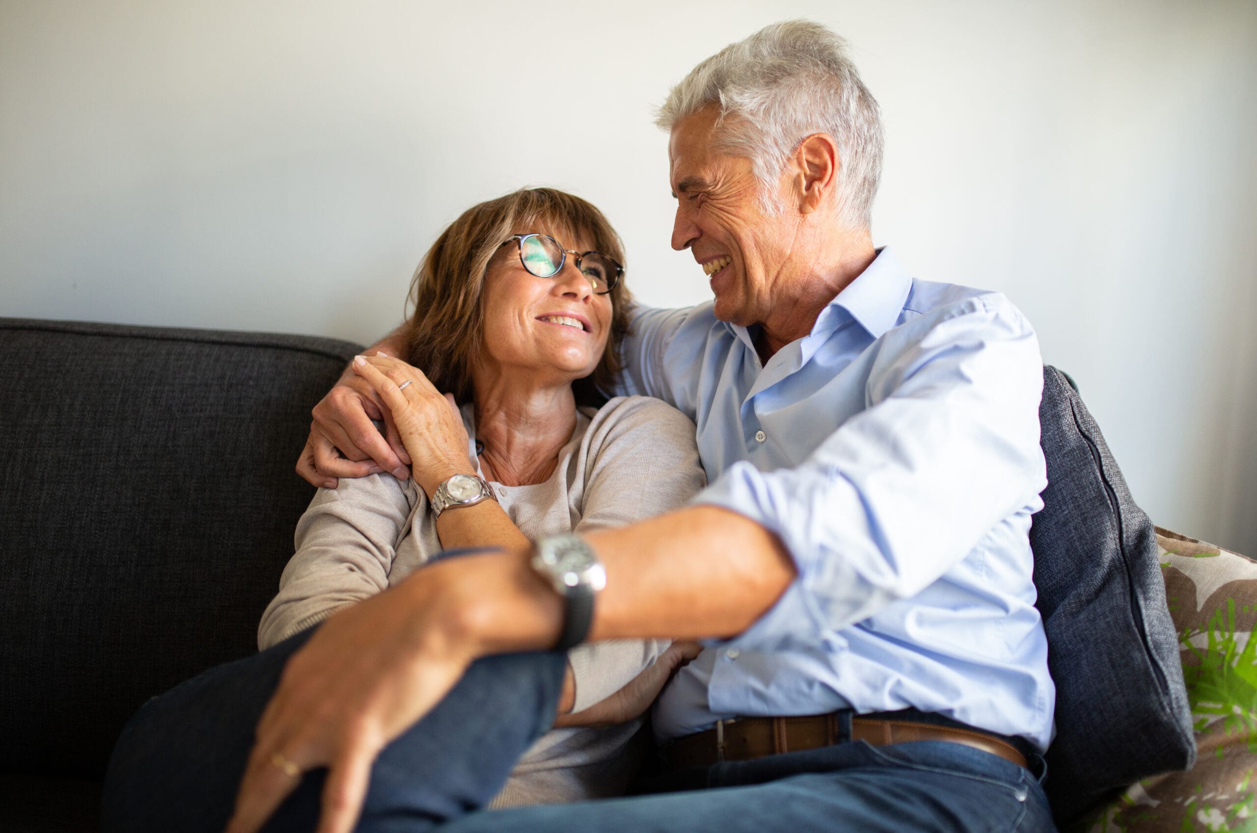 loving-older-couple-sitting-on-sofa-2023-11-27-05-25-35-utc-scaled-min